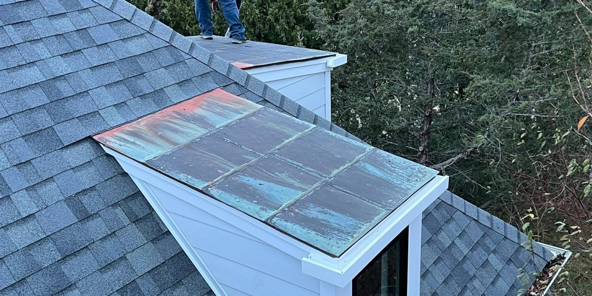 Professional installing gutters on a residential home